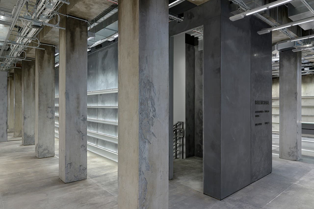 The interior of Balenciaga's New London Store featuring concrete columns and shelves.